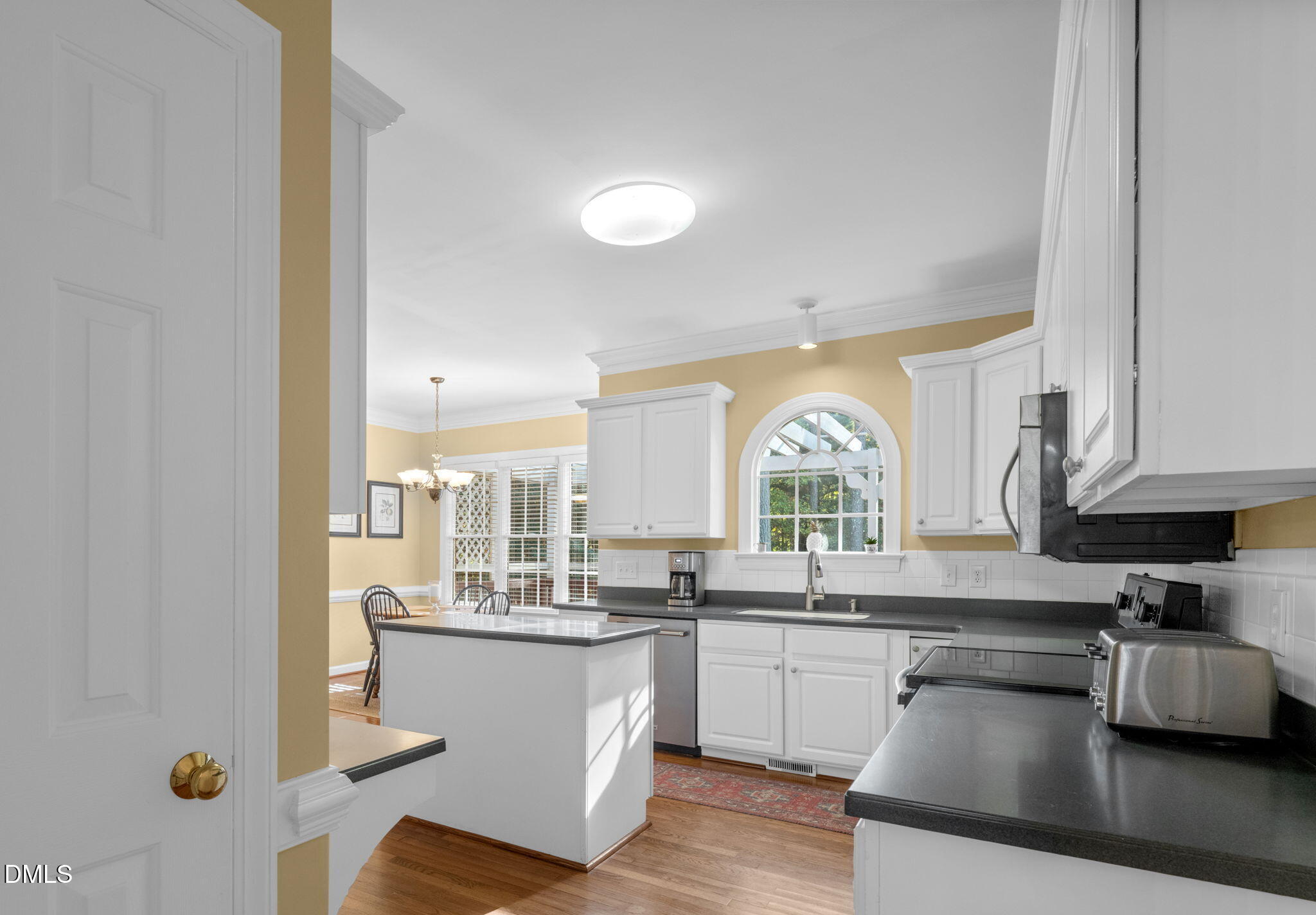 2605 Lizei Street Raleigh, NC 27616 - Photo 14 of 46 a kitchen with a sink cabinets and window