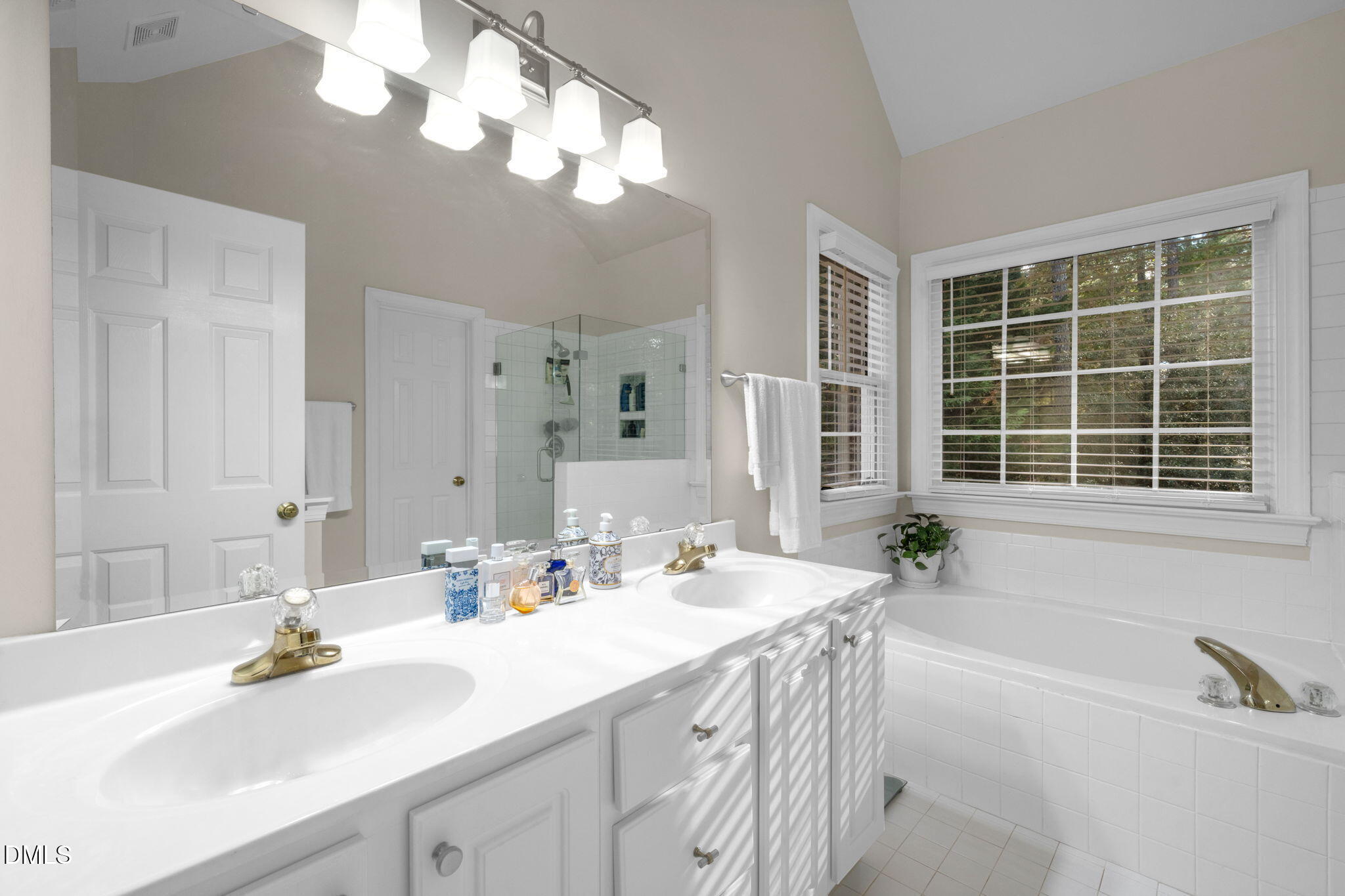2605 Lizei Street Raleigh, NC 27616 - Photo 23 of 46 a bathroom with a sink double vanity and a bathtub