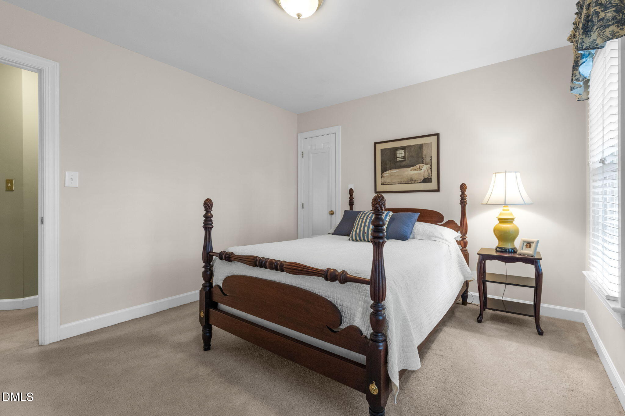2605 Lizei Street Raleigh, NC 27616 - Photo 29 of 46 a bedroom with a bed and a lamp on the dresser