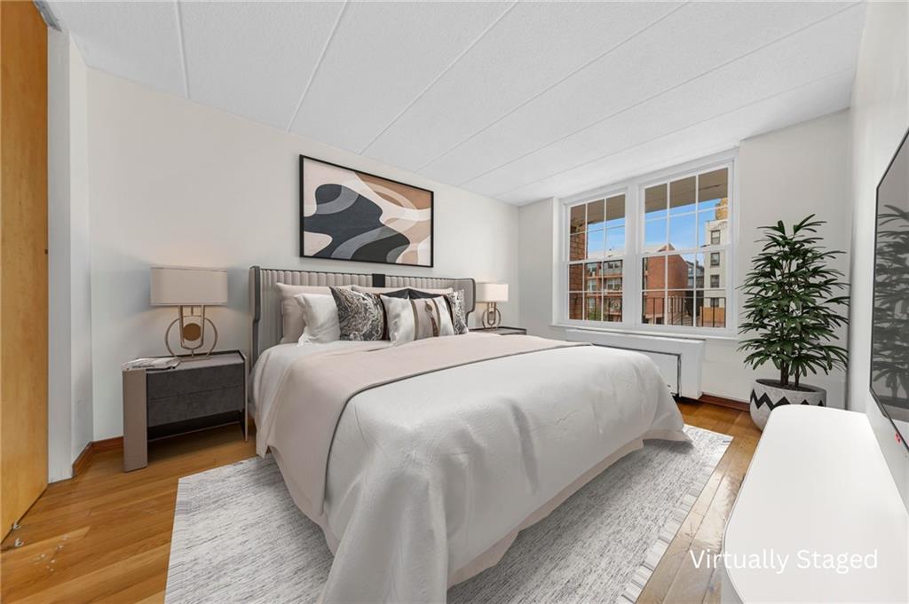 9995 Shore Road, Unit 18D Brooklyn, NY 11209 - Photo 4 of 10 a bedroom with bed and a potted plant