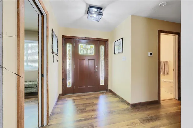 a living room with fireplace furniture and a rug
