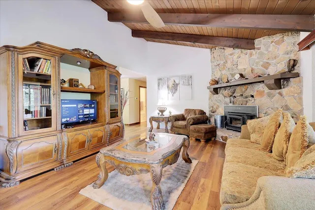 a living room with furniture a large window and a chandelier