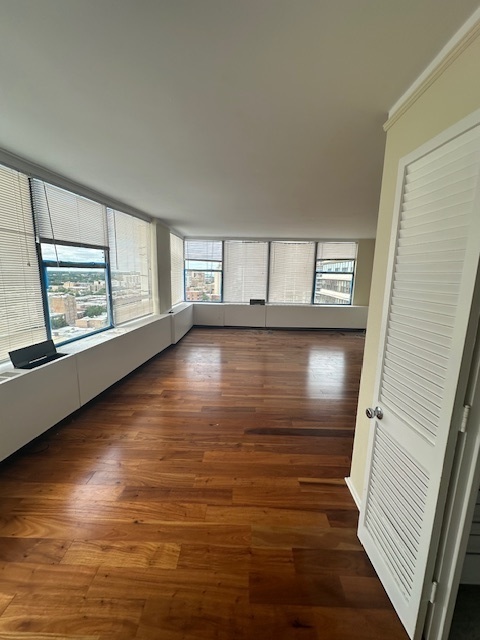 5757 North Sheridan Road, Unit 18J Chicago, IL 60660 - Photo 17 of 19 a view of a room with wooden floor and window