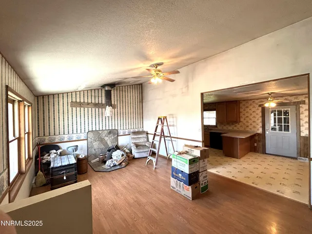 a living room with furniture gym equipment and a large window