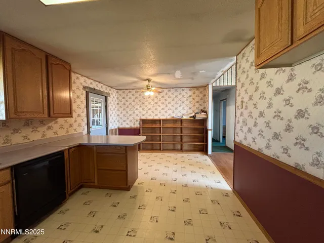 a kitchen with wooden cabinets sink and stove