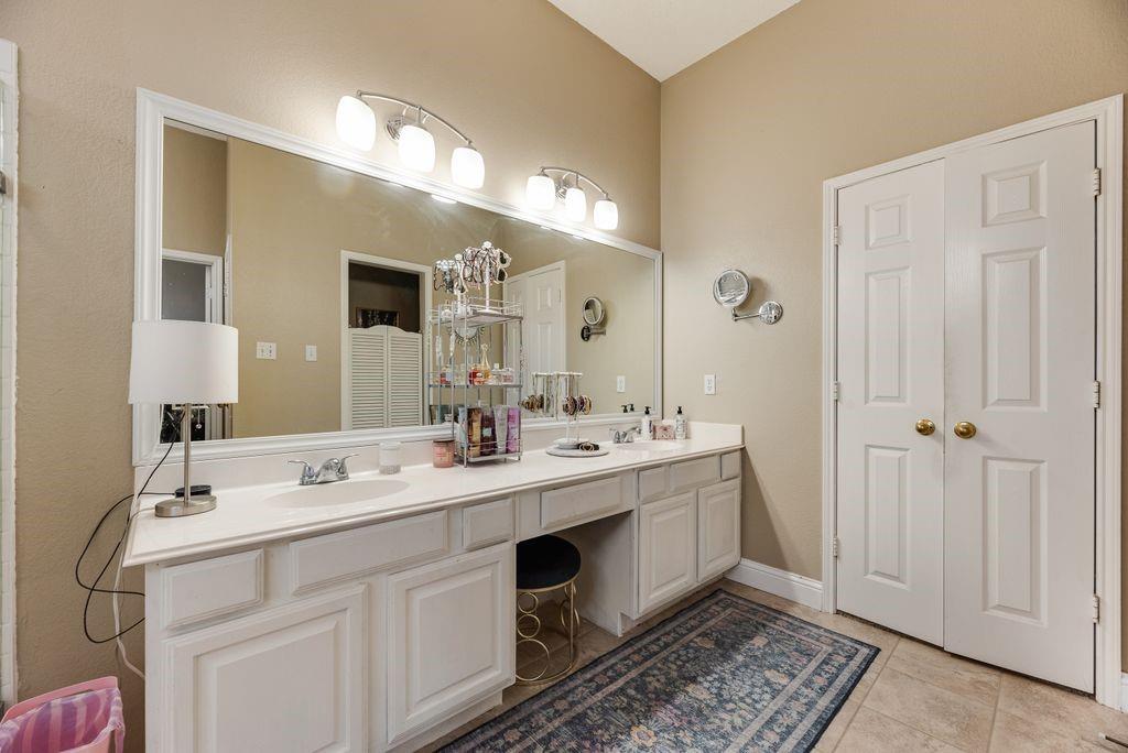 3205 Cape Cod Court Arlington, TX 76017 - Photo 18 of 30 a spacious bathroom with a double vanity sink mirror and