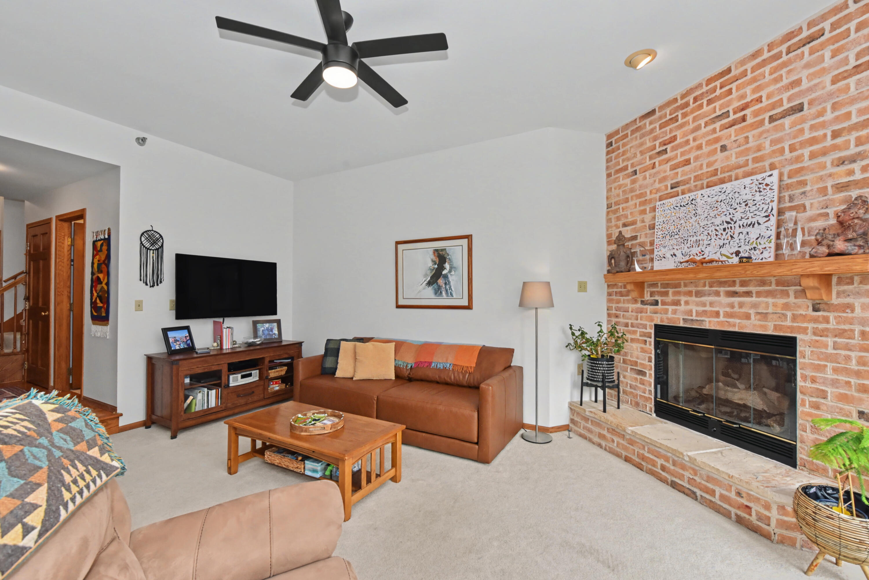 2870 Teal Ridge Court, Unit B Brookfield, WI 53045 - Photo 11 of 42 Sunken living room featuring a cozy gas fireplace and inviting gathering space.