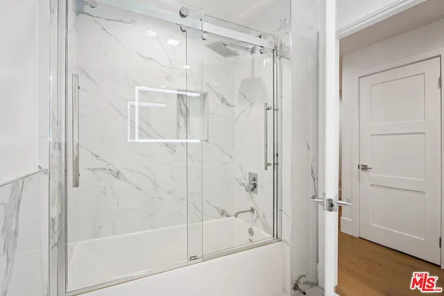 a bathroom with a glass shower door