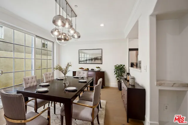 a view of a dining room with furniture and chandelier