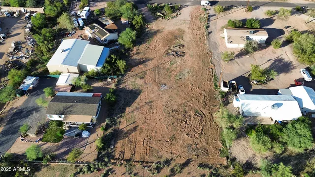 an aerial view of a house with a yard and garden