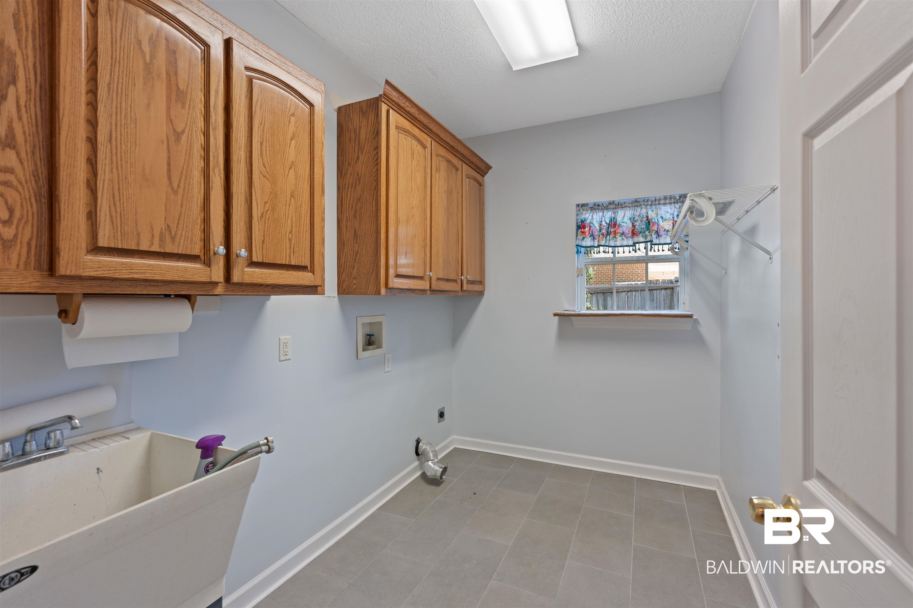 4 Judd Trail Daphne, AL 36527 - Photo 22 of 45 Washroom with a sink, baseboards, cabinet space, and washer hookup