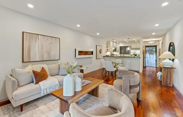 a living room with furniture and kitchen view