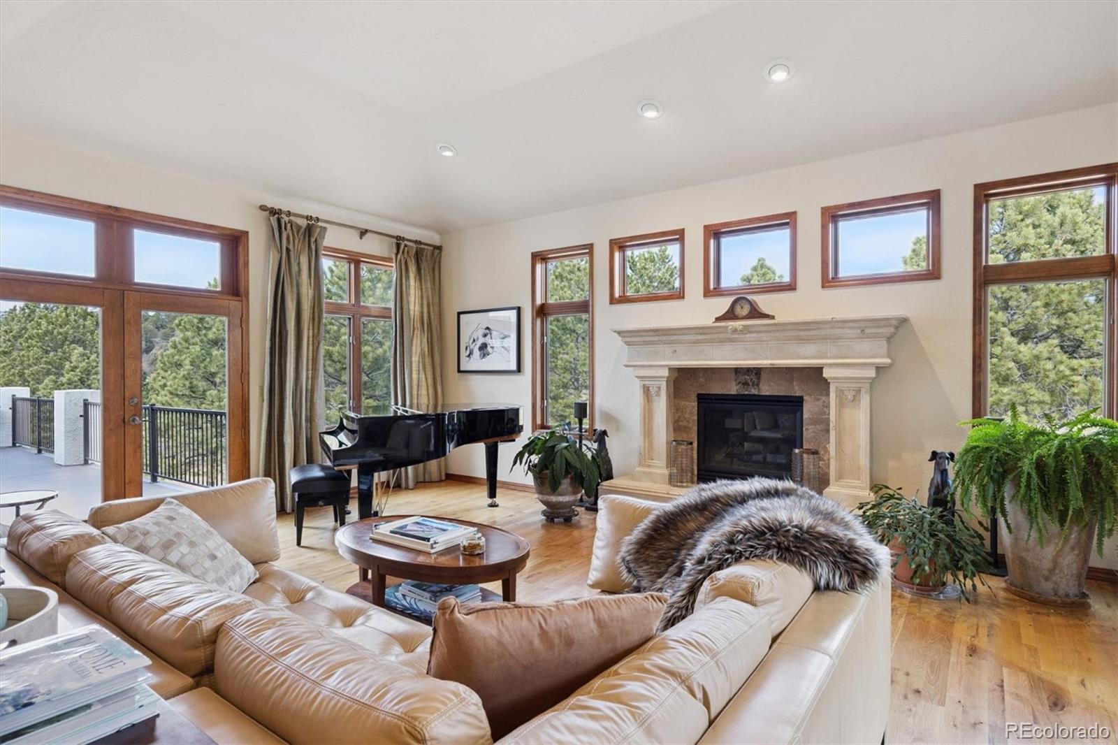 8061 Sugar Loaf Road Larkspur, CO 80118 - Photo 13 of 48 a living room with furniture fireplace and a large window