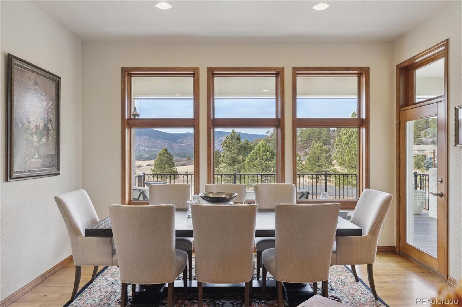 8061 Sugar Loaf Road Larkspur, CO 80118 - Photo 15 of 48 a view of a dining room with furniture window and wooden floor