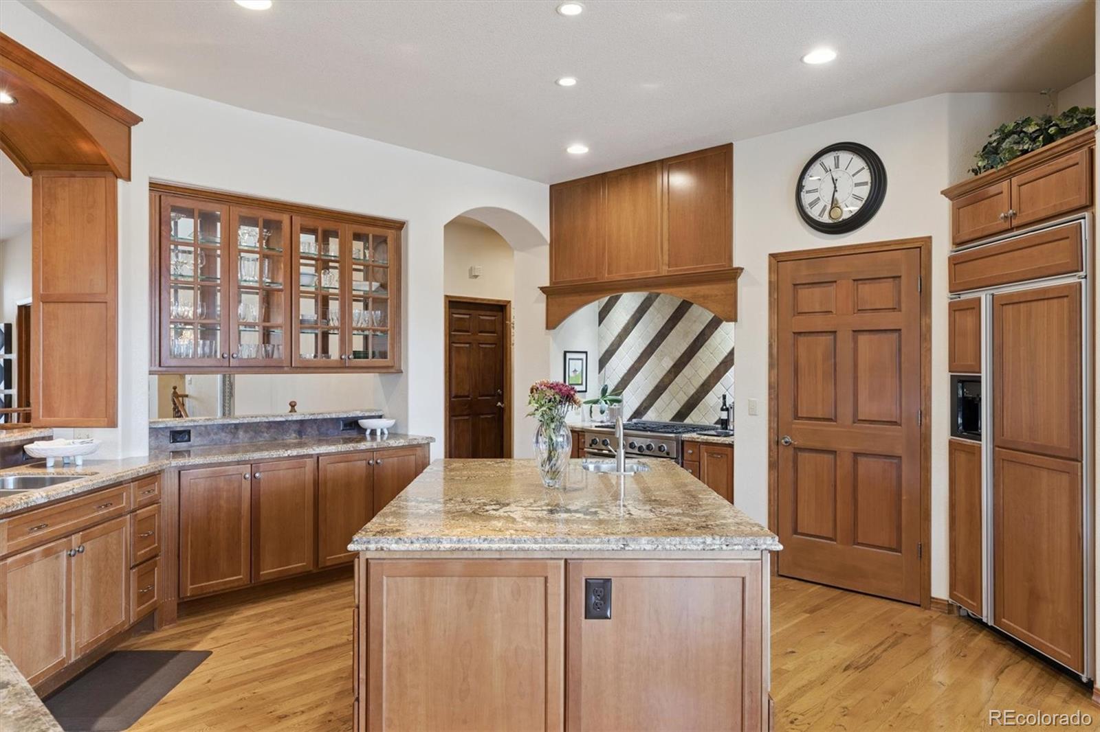 8061 Sugar Loaf Road Larkspur, CO 80118 - Photo 16 of 48 a kitchen with stainless steel appliances granite countertop a stove and a refrigerator