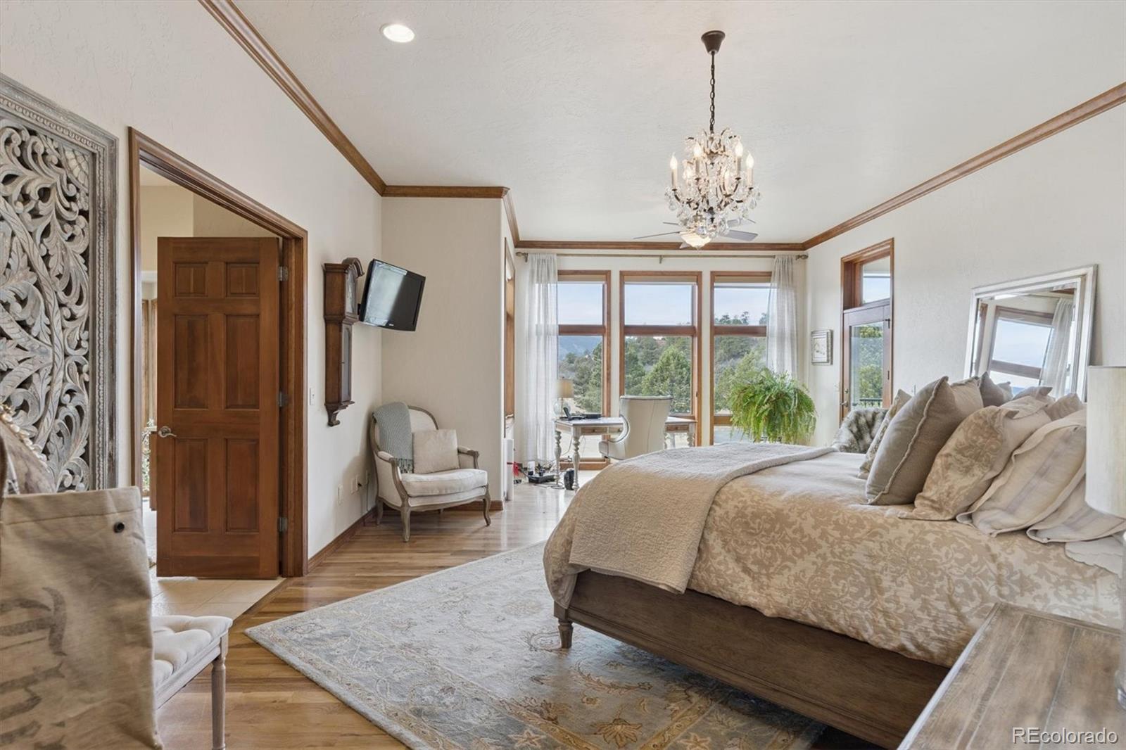8061 Sugar Loaf Road Larkspur, CO 80118 - Photo 17 of 48 a living room with furniture and a chandelier