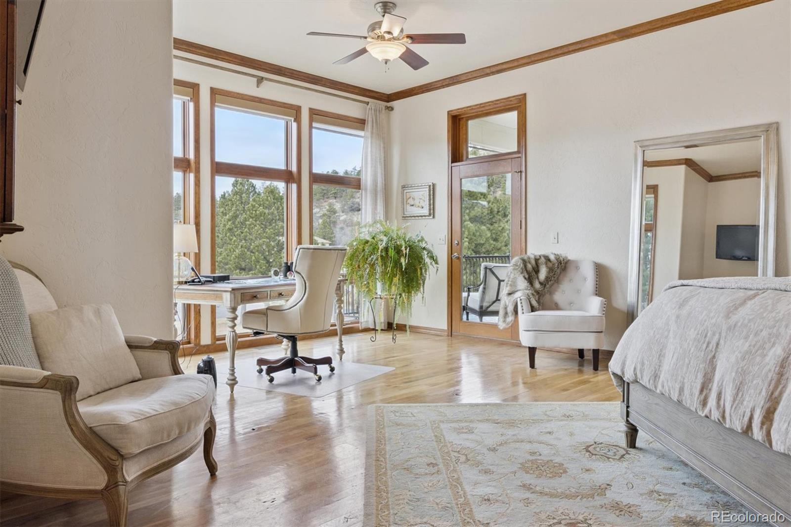 8061 Sugar Loaf Road Larkspur, CO 80118 - Photo 19 of 48 a living room with furniture and floor to ceiling windows