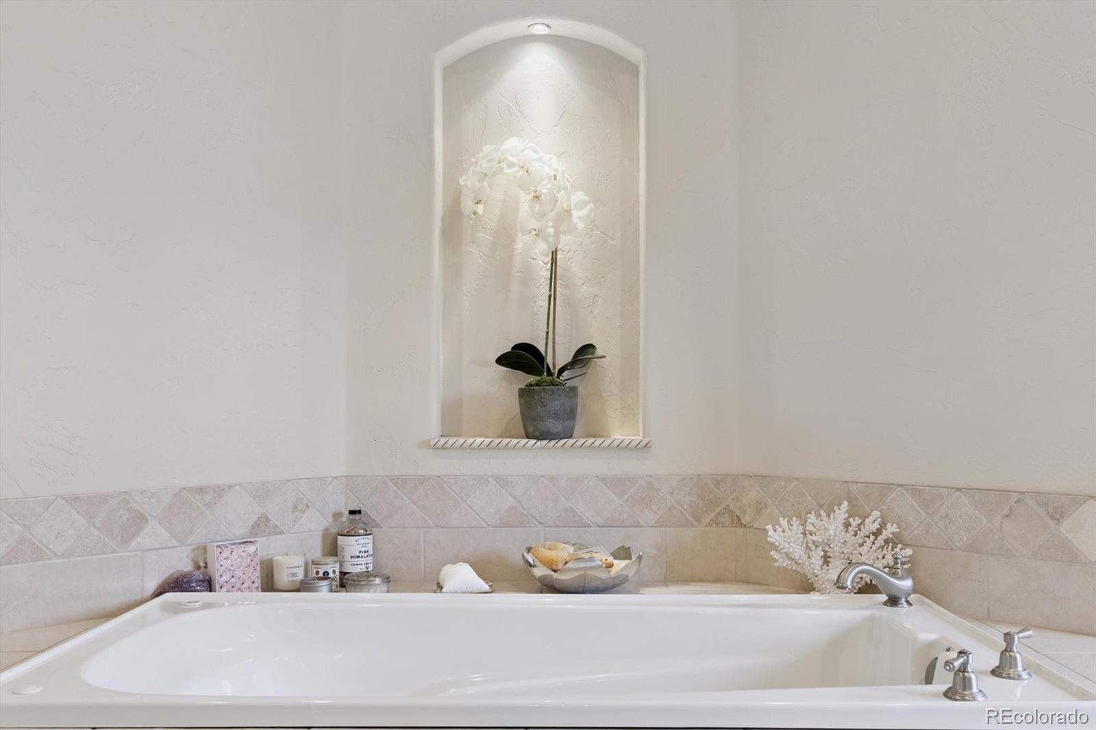 8061 Sugar Loaf Road Larkspur, CO 80118 - Photo 20 of 48 a bathroom with a tub and sink