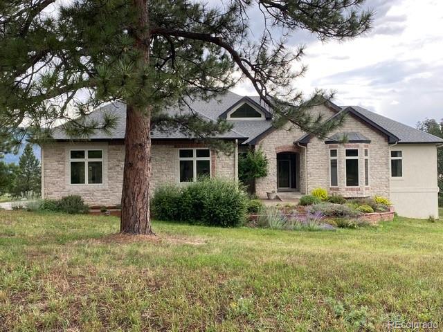 8061 Sugar Loaf Road Larkspur, CO 80118 - Photo 2 of 48 a front view of house with yard and green space