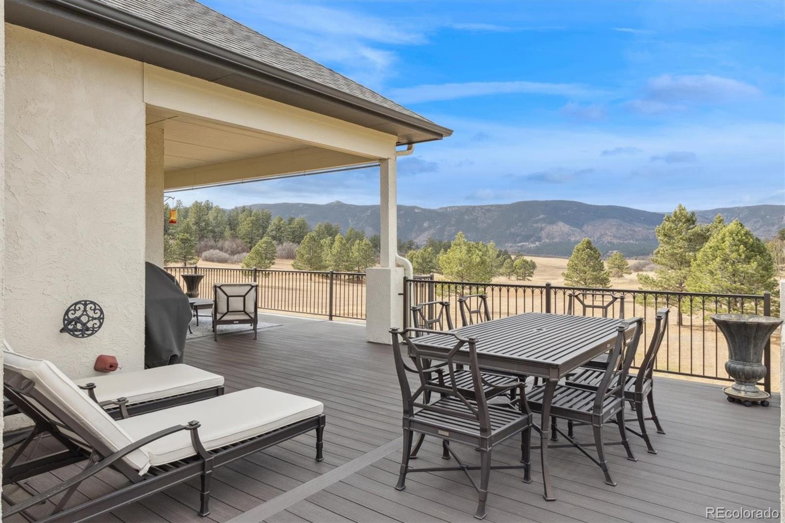 8061 Sugar Loaf Road Larkspur, CO 80118 - Photo 27 of 48 a view of a chairs and table in patio