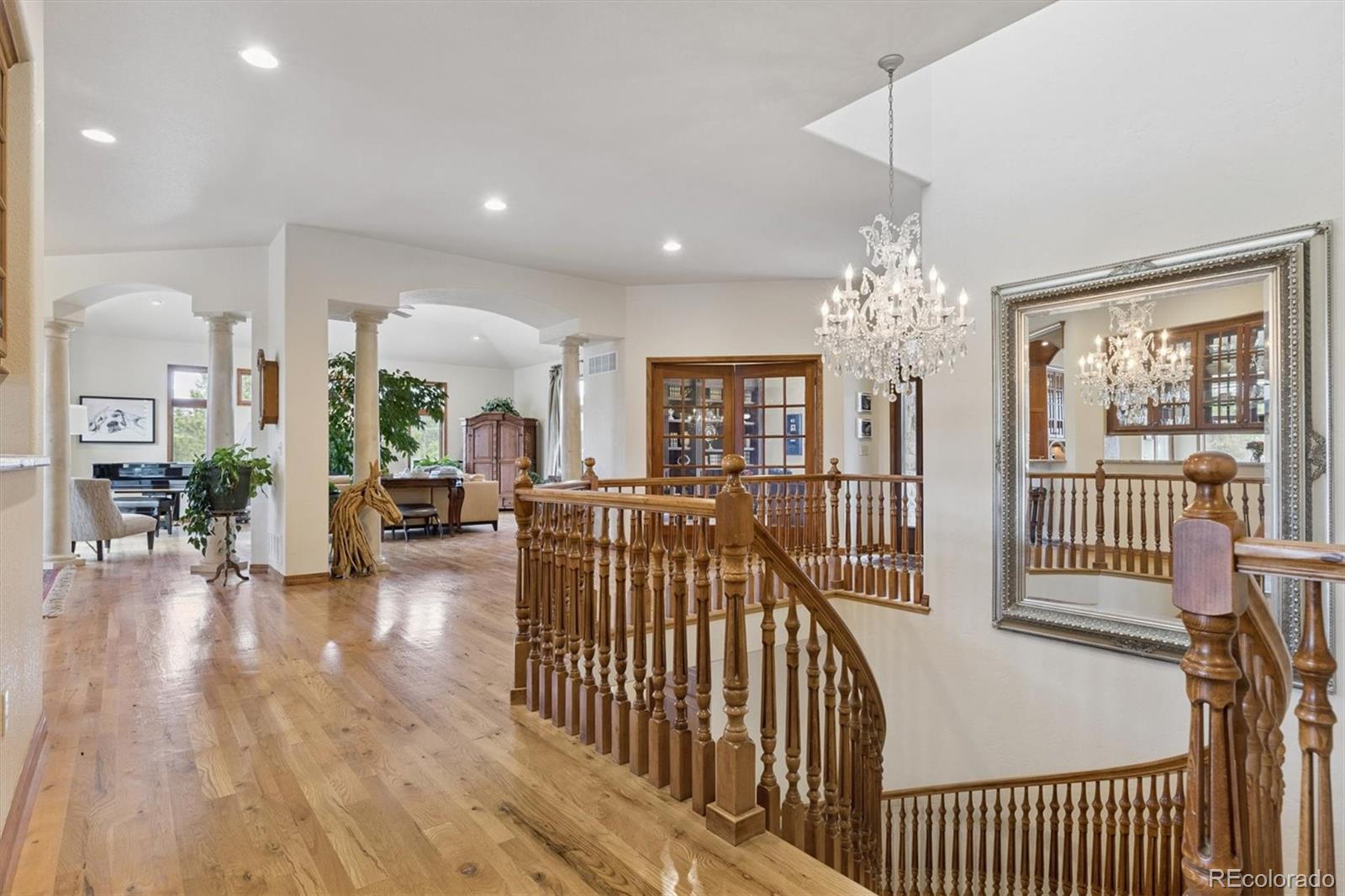 8061 Sugar Loaf Road Larkspur, CO 80118 - Photo 3 of 48 a view of a livingroom with furniture wooden floor and windows