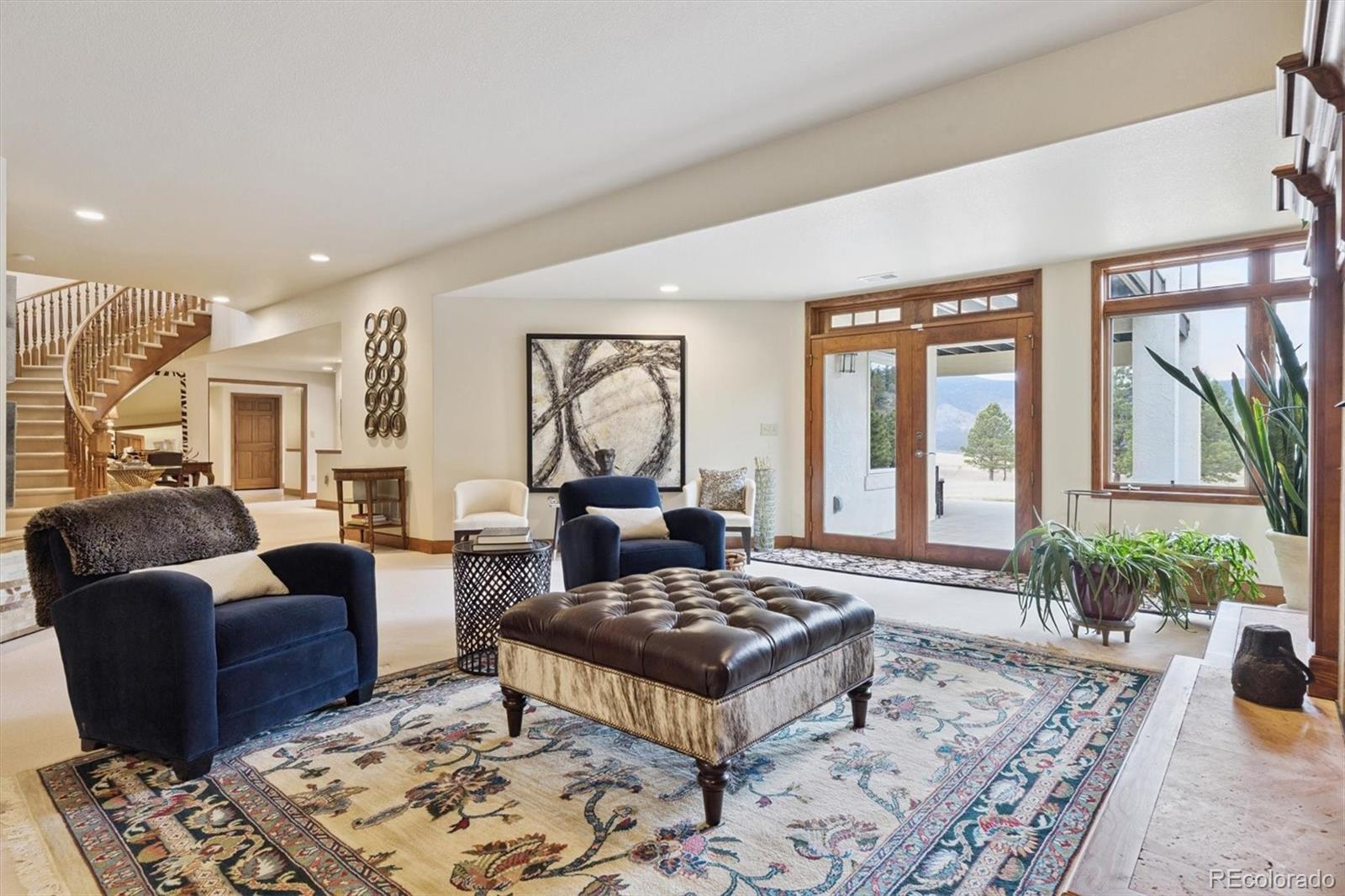 8061 Sugar Loaf Road Larkspur, CO 80118 - Photo 34 of 48 a living room with furniture and a large window