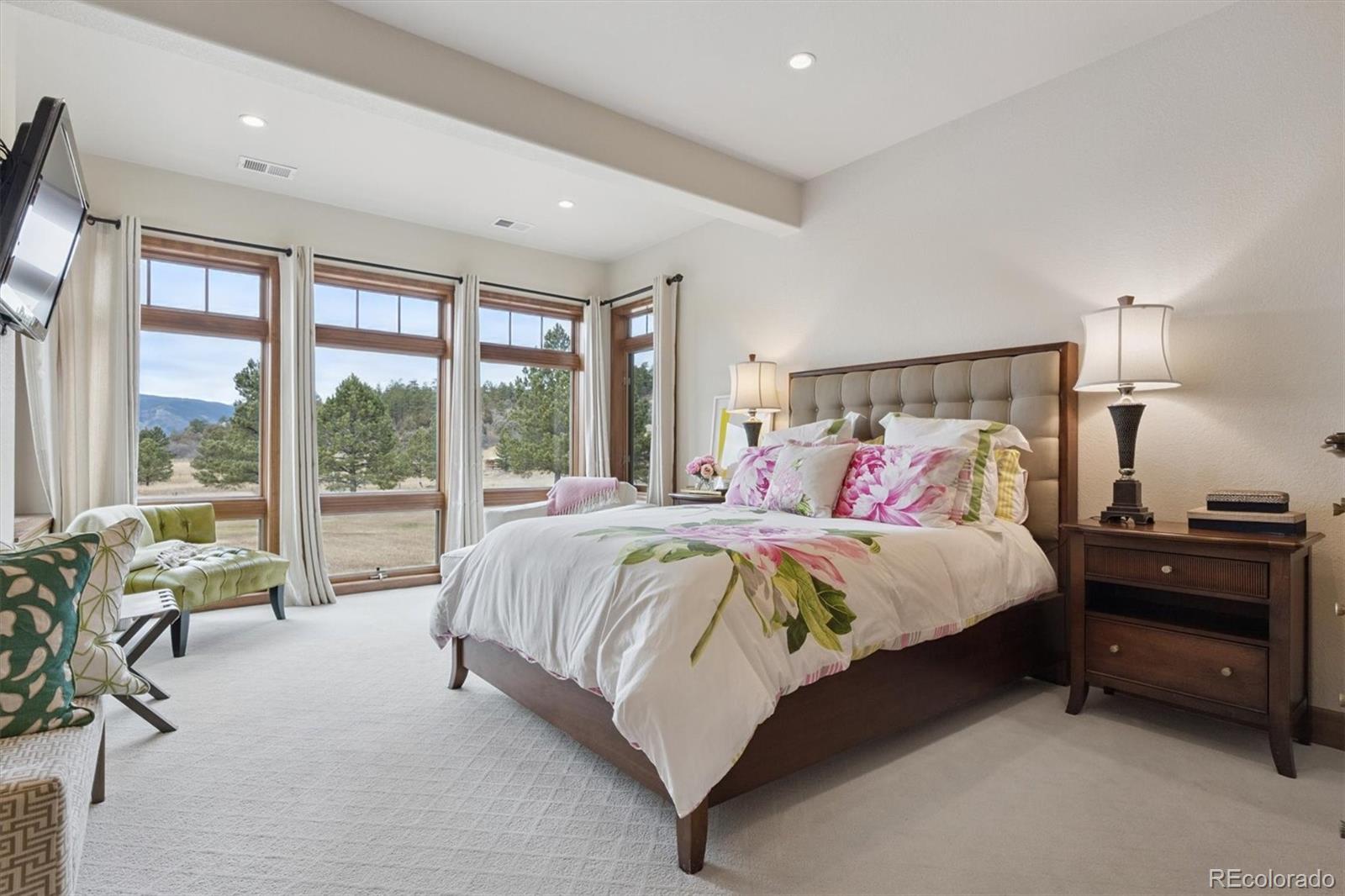 8061 Sugar Loaf Road Larkspur, CO 80118 - Photo 42 of 48 a spacious bedroom with a bed and a large window