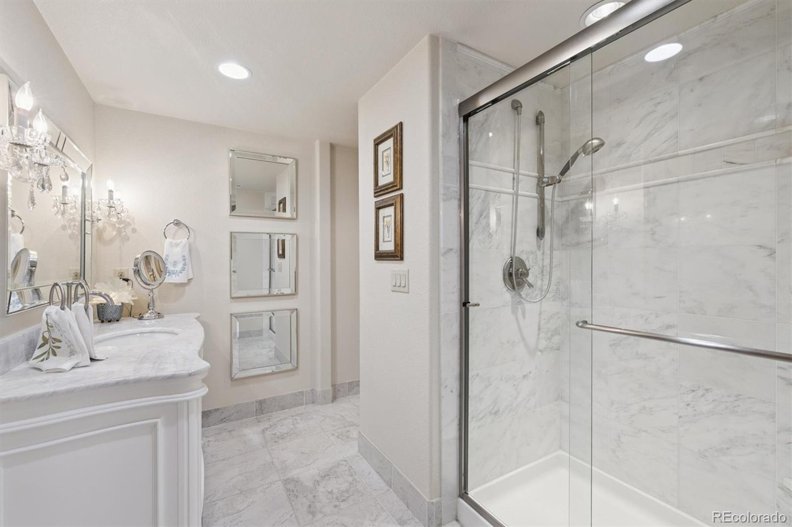 8061 Sugar Loaf Road Larkspur, CO 80118 - Photo 44 of 48 a bathroom with a shower sink and mirror