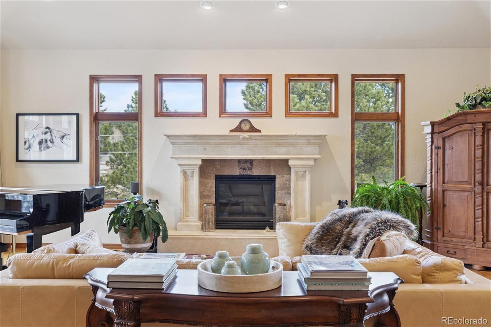 8061 Sugar Loaf Road Larkspur, CO 80118 - Photo 6 of 48 a living room with furniture and a fireplace