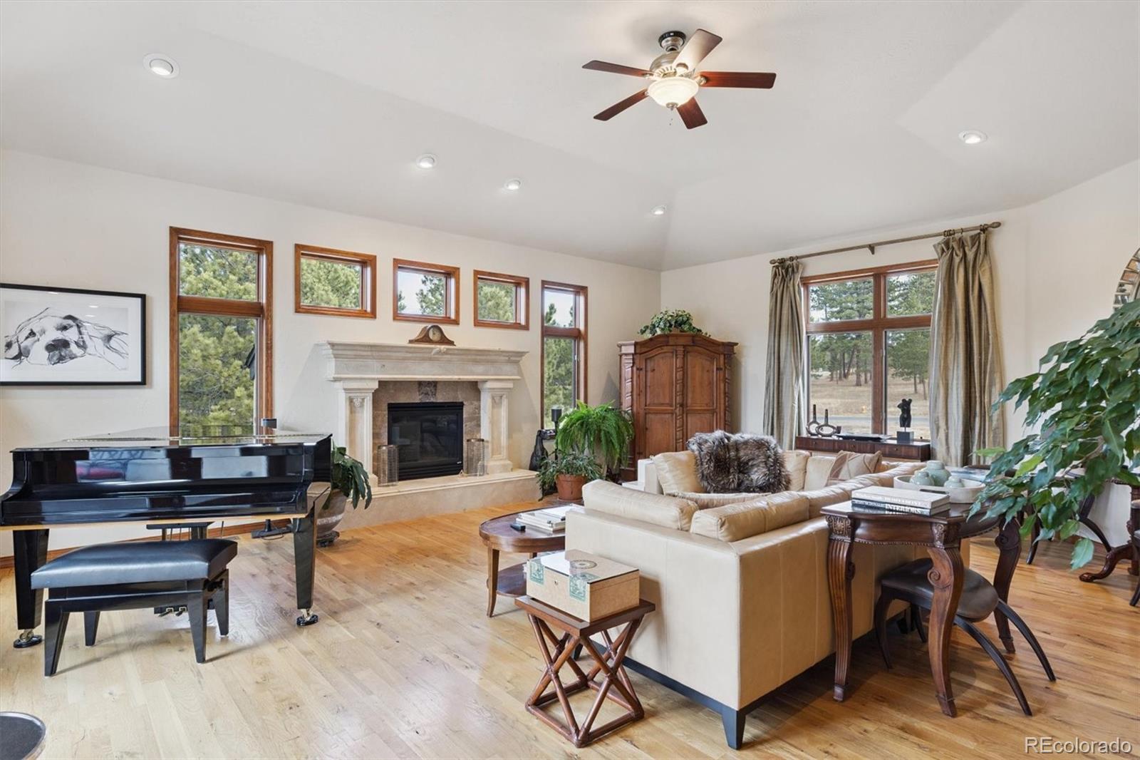 8061 Sugar Loaf Road Larkspur, CO 80118 - Photo 7 of 48 a living room with furniture fireplace and window