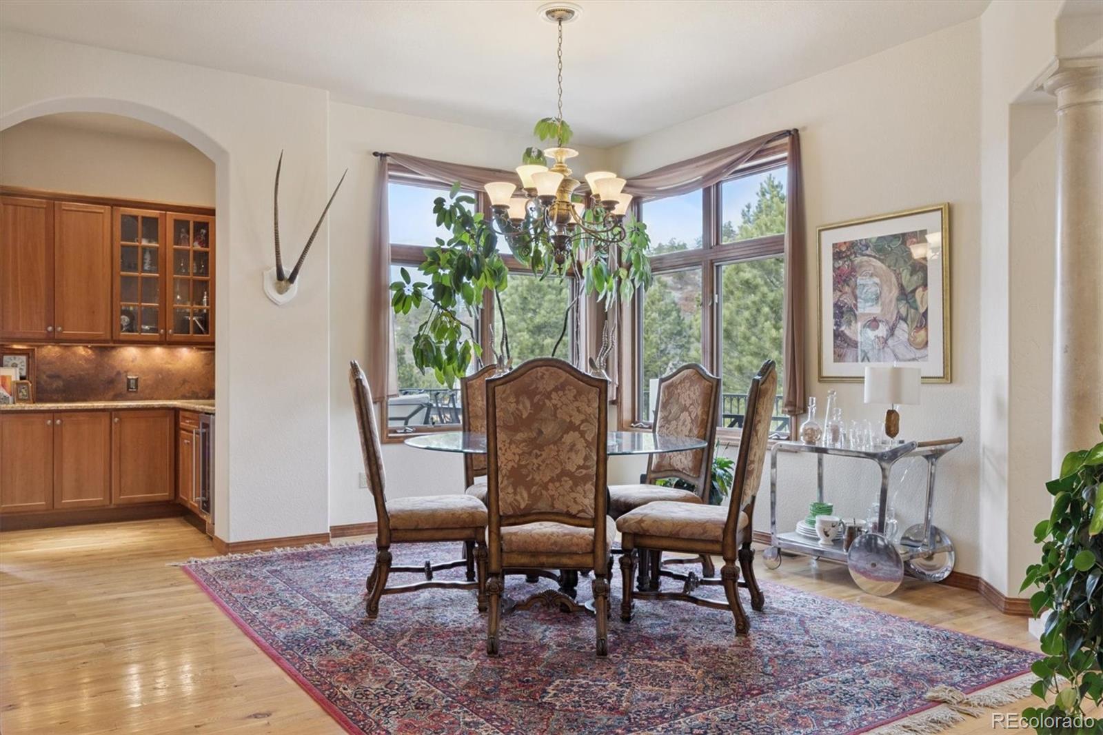 8061 Sugar Loaf Road Larkspur, CO 80118 - Photo 8 of 48 a view of a dining room with furniture window and outside view