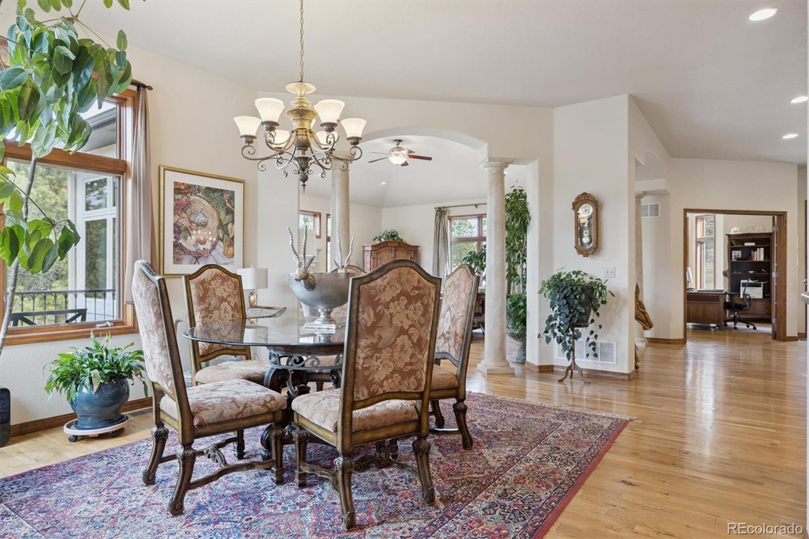 8061 Sugar Loaf Road Larkspur, CO 80118 - Photo 9 of 48 a view of a dining room with furniture wooden floor and chandelier