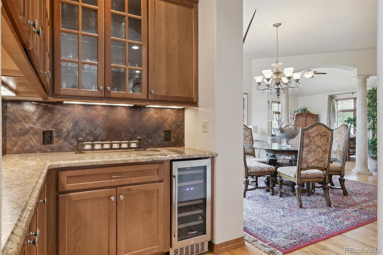 8061 Sugar Loaf Road Larkspur, CO 80118 - Photo 10 of 48 a view of a dining room with furniture and chandelier