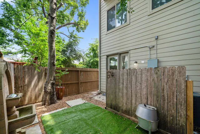 a view of a backyard with wooden fence and a stairs