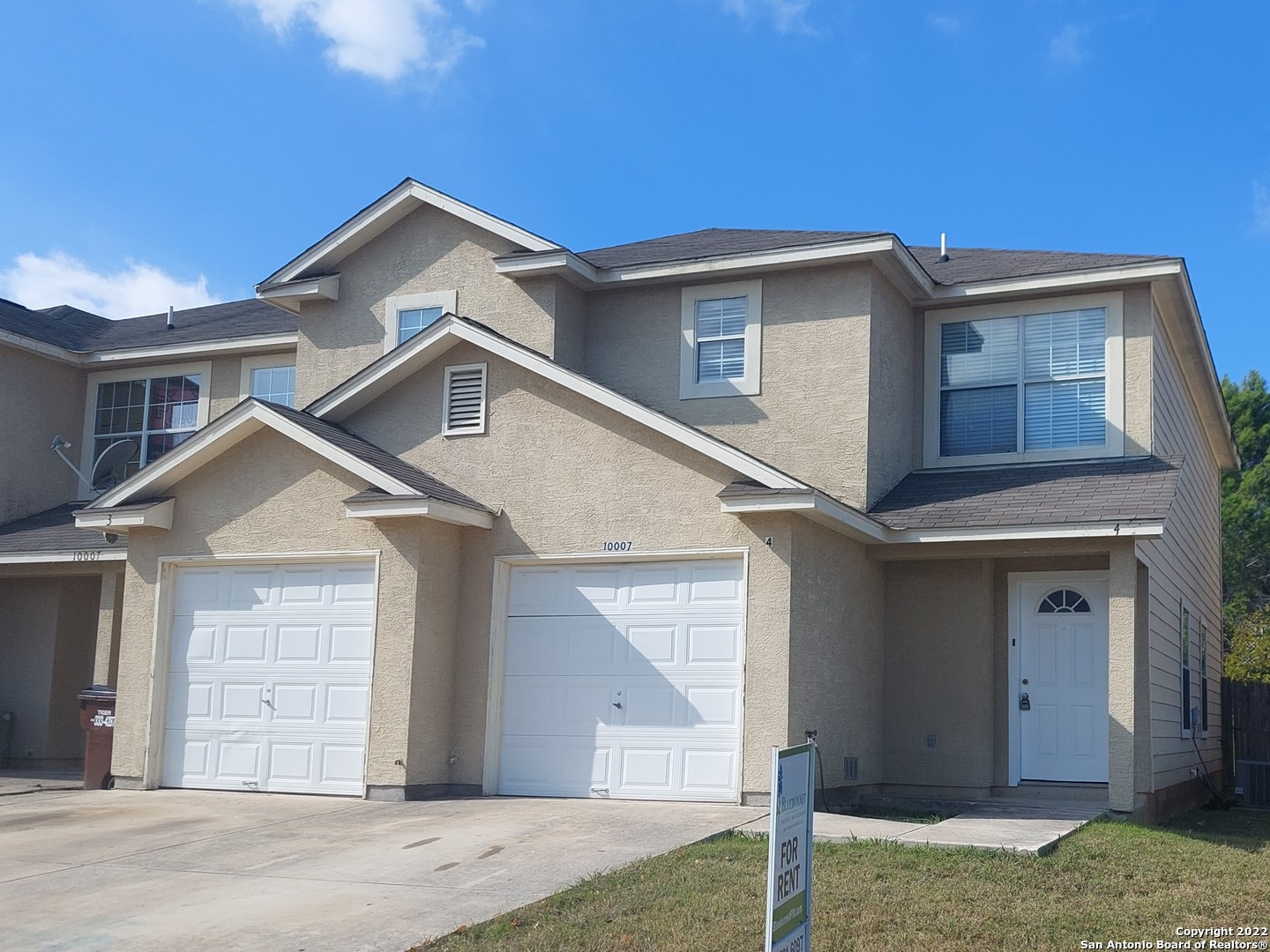 10007 Vasso View, Unit 3 Converse, TX 78109 - Photo 1 of 4 a front view of a house with a yard