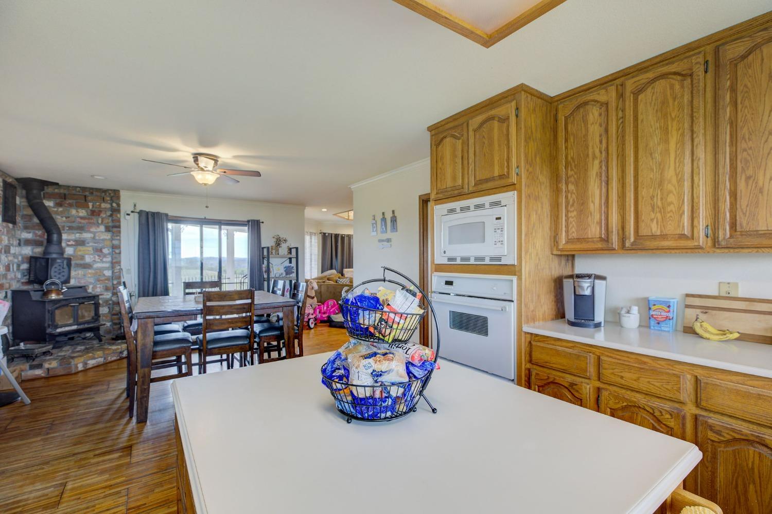 1095 Cold Springs Road Placerville, CA 95667 - Photo 16 of 55 a kitchen with stainless steel appliances a stove a refrigerator sink cabinets dining table and chairs
