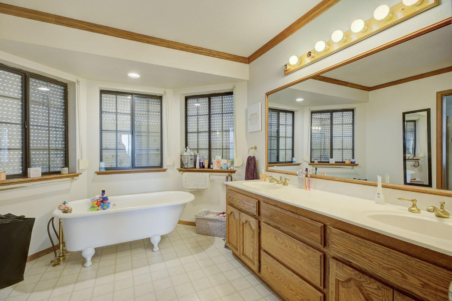1095 Cold Springs Road Placerville, CA 95667 - Photo 27 of 55 a spacious bathroom with a bathtub a double vanity sink and a large mirror