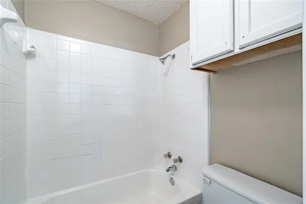 a bathroom with a bathtub and shower
