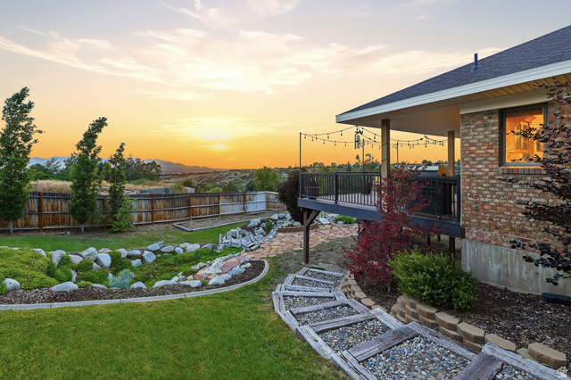 2342 Charros Road Sandy, UT 84092 - Photo 71 of 94 Expansive backyard featuring a manicured lawn, established landscaping, and a wooden privacy fence