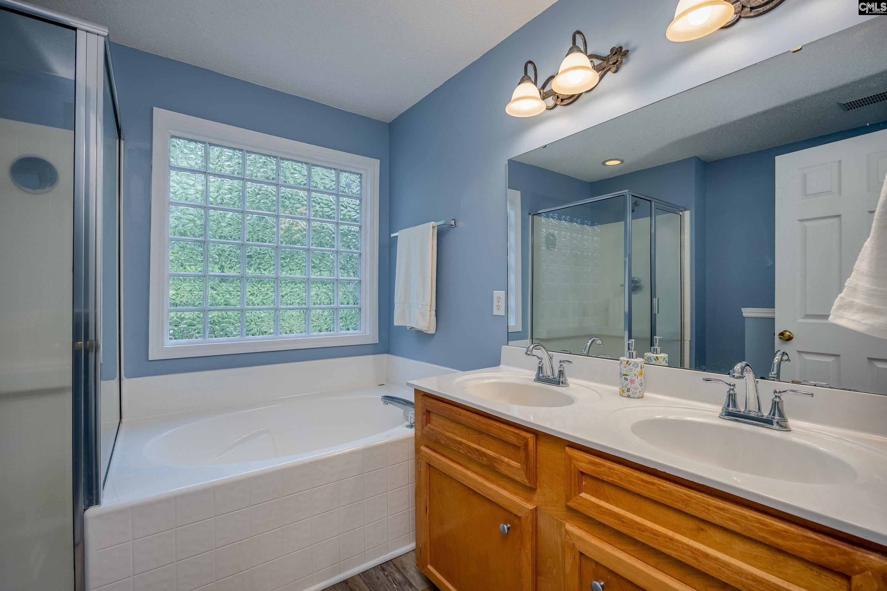 2032 Ridgeway Road Lugoff, SC 29078 - Photo 31 of 57 a bathroom with a tub double sink and a mirror