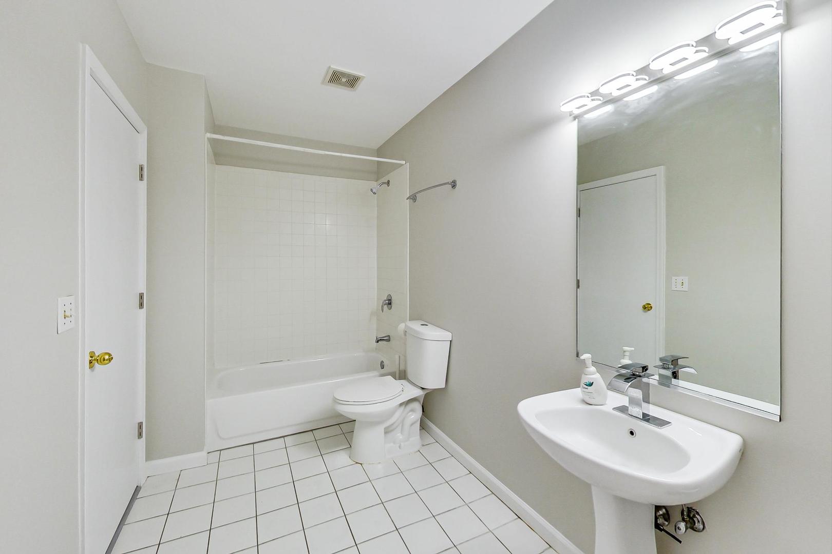 2101 West Rice Street, Unit 103 Chicago, IL 60622 - Photo 18 of 44 a bathroom with a sink toilet and shower