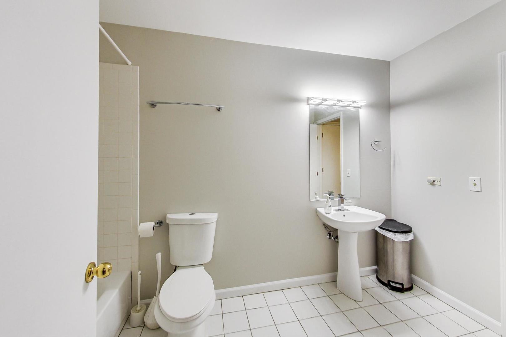 2101 West Rice Street, Unit 103 Chicago, IL 60622 - Photo 19 of 44 a white toilet sitting next to a bathroom sink