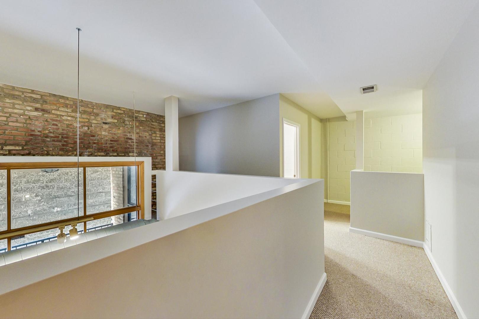 2101 West Rice Street, Unit 103 Chicago, IL 60622 - Photo 21 of 44 a view of an empty room with windows