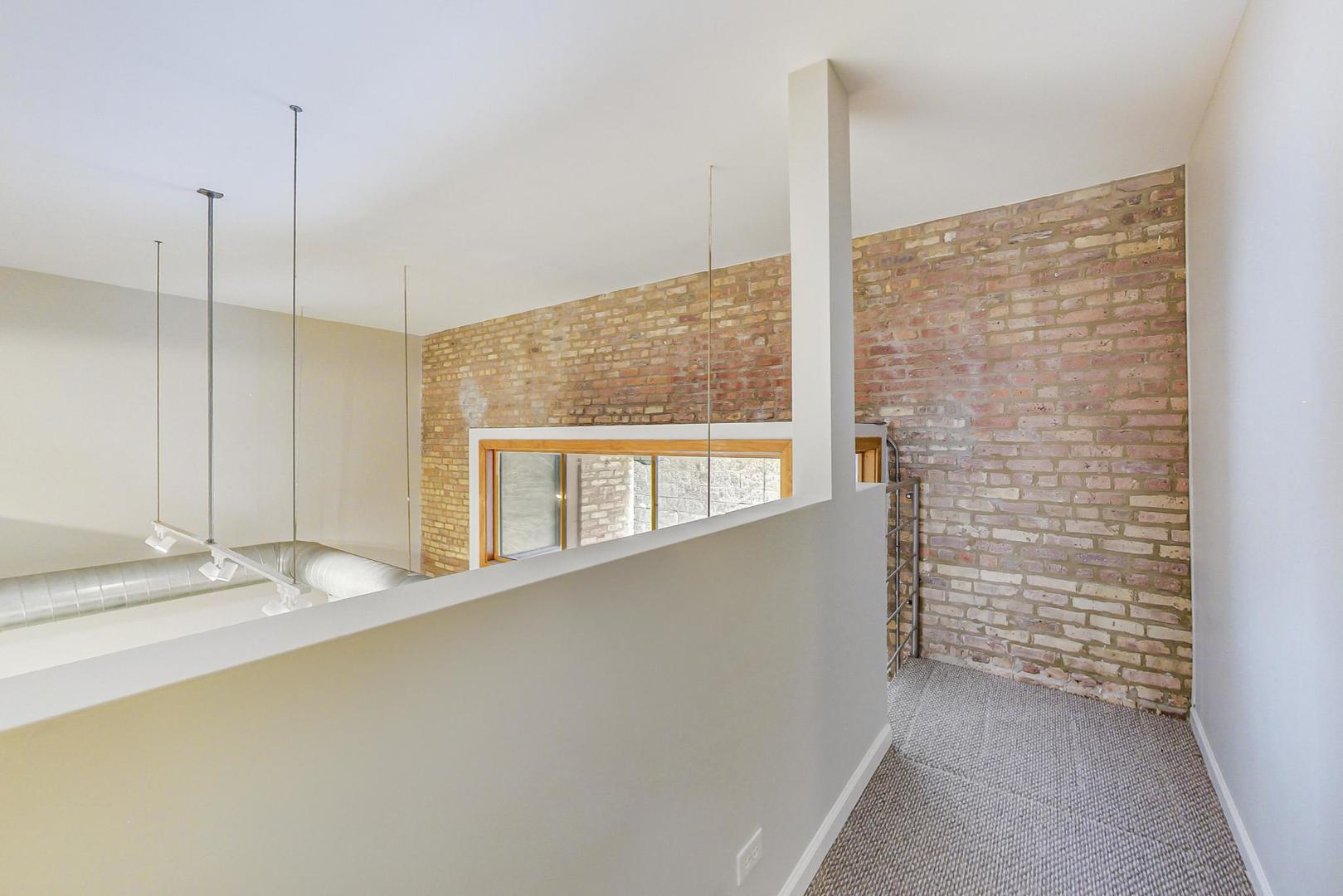 2101 West Rice Street, Unit 103 Chicago, IL 60622 - Photo 22 of 44 a view of an empty room and window