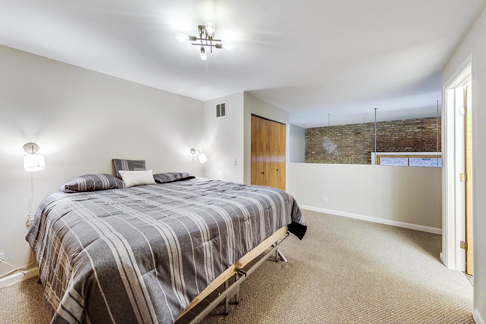 2101 West Rice Street, Unit 103 Chicago, IL 60622 - Photo 28 of 44 a bedroom with a bed and a window
