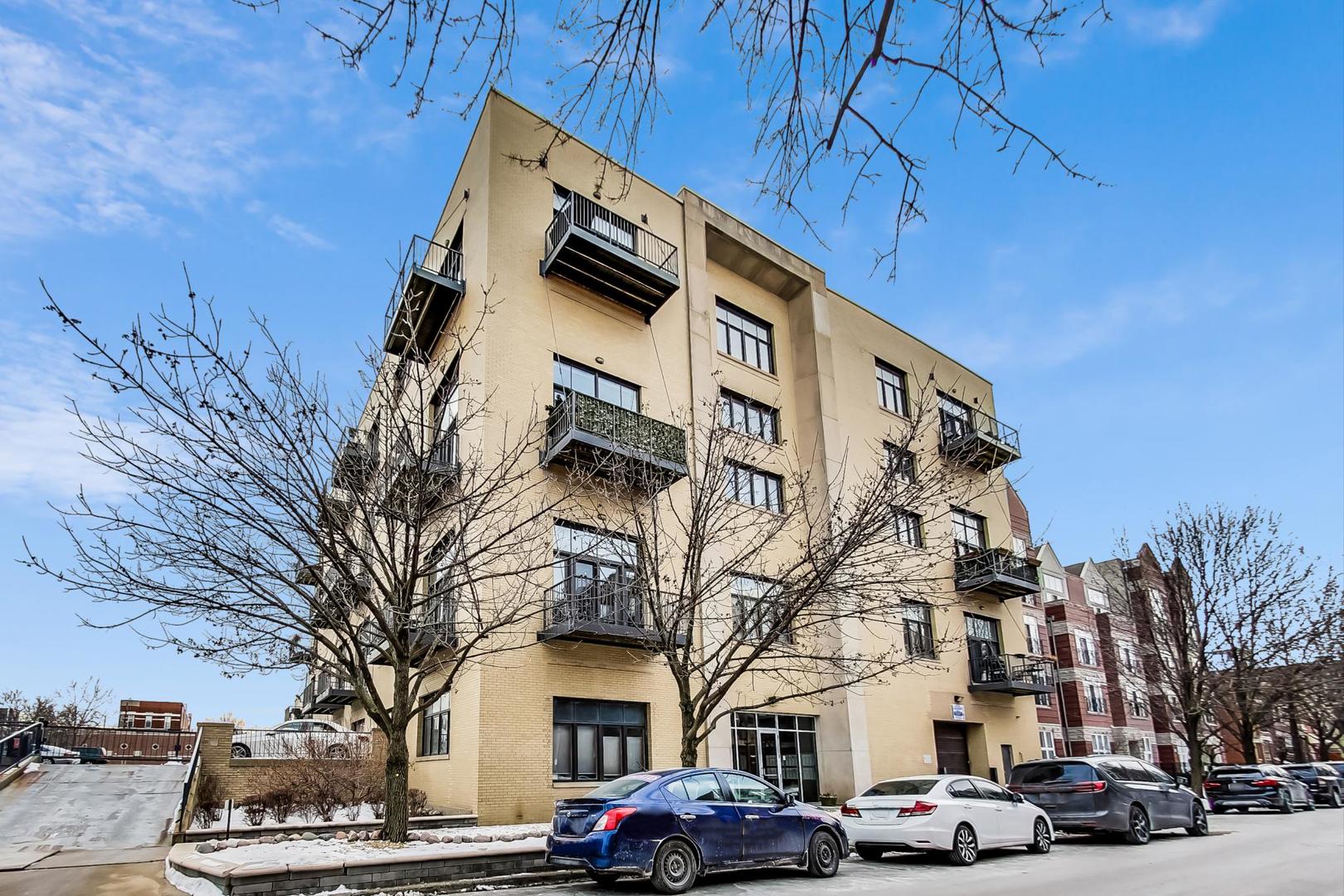 2101 West Rice Street, Unit 103 Chicago, IL 60622 - Photo 3 of 44 a city street lined with buildings and cars