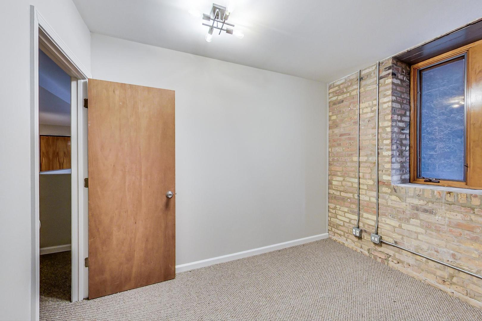 2101 West Rice Street, Unit 103 Chicago, IL 60622 - Photo 31 of 44 an empty room with windows