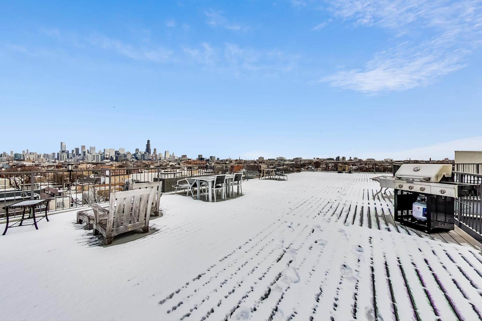 2101 West Rice Street, Unit 103 Chicago, IL 60622 - Photo 37 of 44 a terrace with outdoor seating and city view