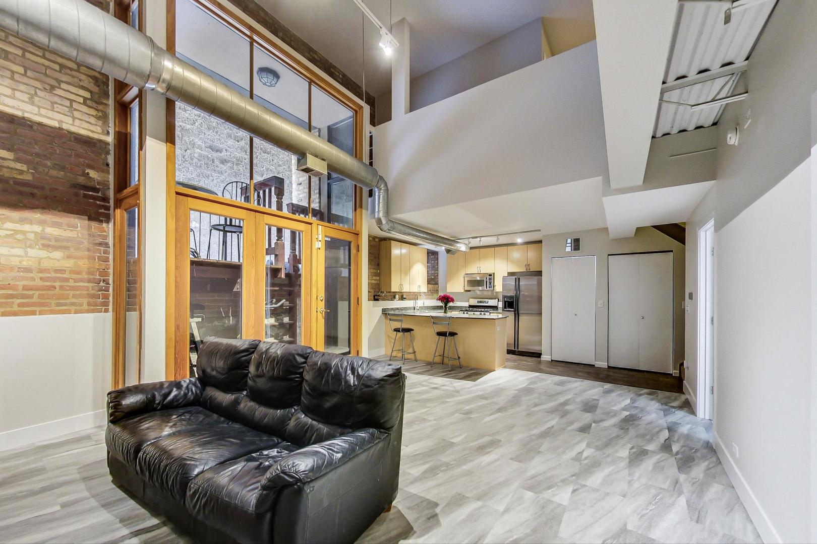 2101 West Rice Street, Unit 103 Chicago, IL 60622 - Photo 9 of 44 a living room with furniture and large windows