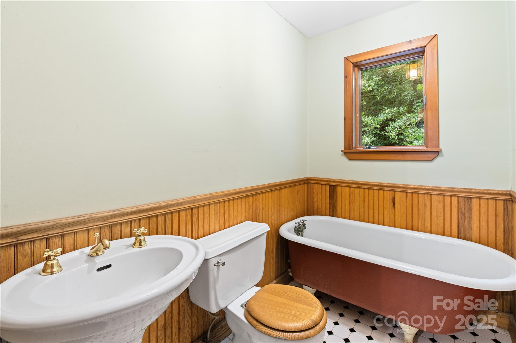 32 Delano Road Asheville, NC 28805 - Photo 16 of 46 a bathroom with a toilet a sink and a window